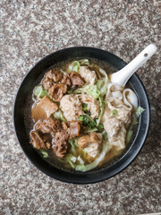 chinese breakfast of soup with meat, dumplings and vegetables