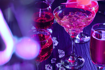 Cocktail drinks with ice in club lights