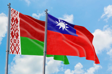 Taiwan and Belarus flags waving in the wind against white cloudy blue sky together. Diplomacy concept, international relations.