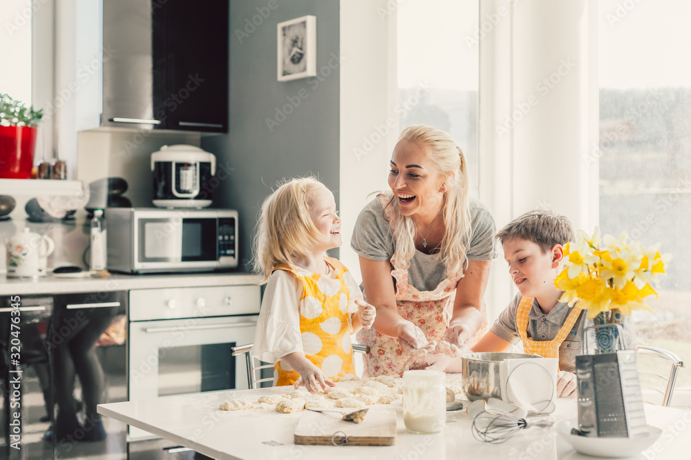 Wall mural mom cooking with kids on the kitchen