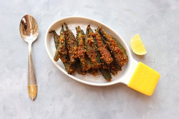 Indian stuffed masala bhindi or Okra or Ladyfinger. Served with lemon wedge. Fried Bhindi is perfect lunch or dinner dish. Copy space.