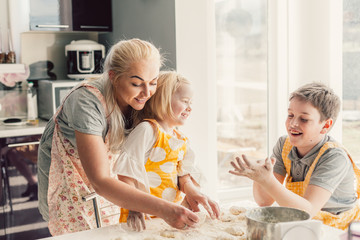 Mom cooking with kids on the kitchen