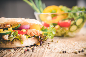 Delicious sandwich on wooden table. Tasty fast food