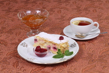 Tea with jam and cake from puff pastry with cherry