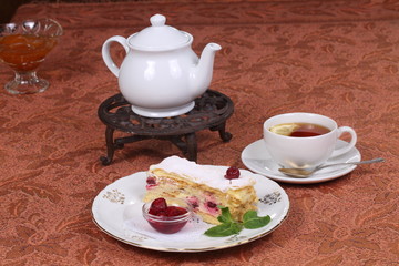 Tea with jam and cake from puff pastry with cherry