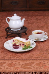 Tea with jam and cake from puff pastry with cherry
