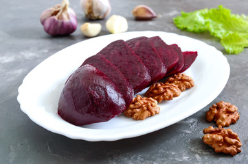 Slices of boiled beets on a white plate. Source of energy. Dietary healthy vegetable.