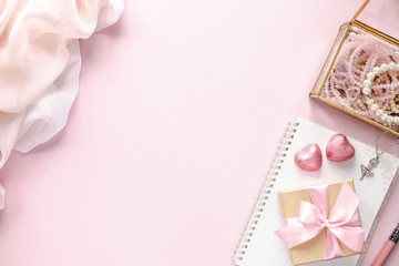 Gift box or gift box and flowers on pink table top view. Flat lay. Birthday, wedding, valentines day, march 8th concept. Place for your text.