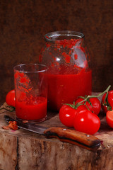 Still life with tomato juice on a wooden table