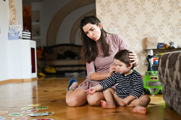 Fototapeta premium The child spends time with his mother. Baby boy and insects. Mom and baby are studying nature.