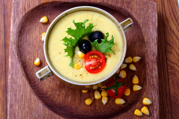 Corn porridge on wooden background