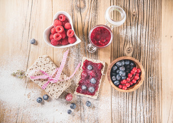Pastry appetizers with blueberries, cranberries and raspberries.