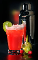 Bright exotic cocktail in a glass on a black background.