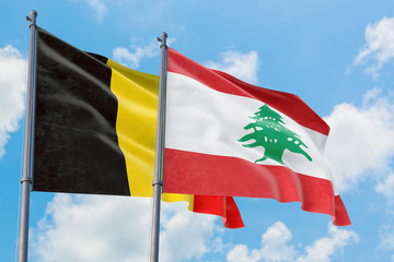 Lebanon and Belgium flags waving in the wind against white cloudy blue sky together. Diplomacy concept, international relations.