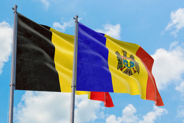 Moldova and Belgium flags waving in the wind against white cloudy blue sky together. Diplomacy concept, international relations.
