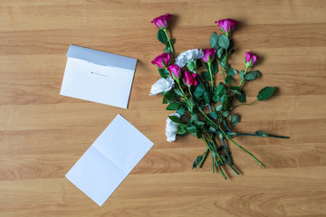Fototapeta na wymiar paper of letter and scattered flowers on the floor. Broken relationships in bad Valentine's day. concept.