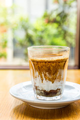 Glass of Nitro Cold Brew Coffee on wood  Table in Coffee Shop, Fresh Drink Compost