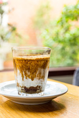 Glass of Nitro Cold Brew Coffee on wood  Table in Coffee Shop, Fresh Drink Compost