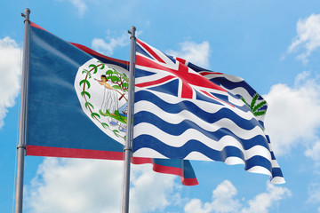 British Indian Ocean Territory and Belize flags waving in the wind against white cloudy blue sky together. Diplomacy concept, international relations.