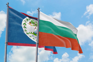 Bulgaria and Belize flags waving in the wind against white cloudy blue sky together. Diplomacy concept, international relations.