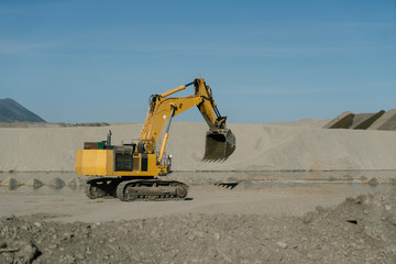 The work of an excavator at the site of gold mining.