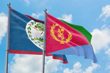 Eritrea and Belize flags waving in the wind against white cloudy blue sky together. Diplomacy concept, international relations.
