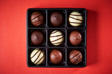 Assorted chocolate truffle on red background 