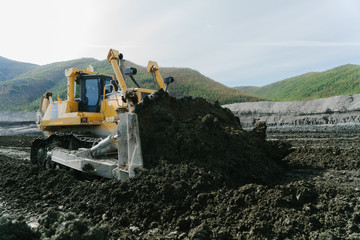 The work of the bulldozer at the mine.