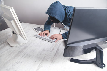  Hacker stealing information from the office computer. Hacking, Criminal