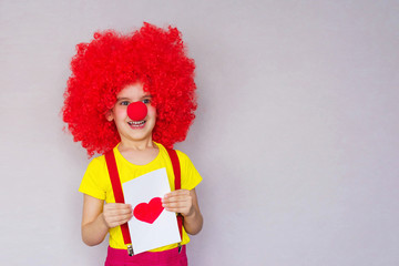 Happy Valentine's Day. Let's celebrate! Funny baby clown playing at home. April 1 concept of April fool's Day. Selective focus.
