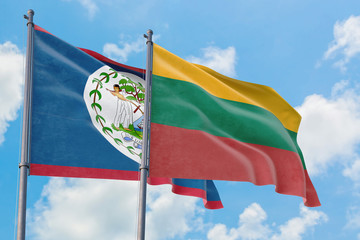 Lithuania and Belize flags waving in the wind against white cloudy blue sky together. Diplomacy concept, international relations.