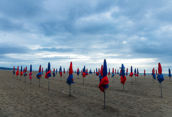 Wide-angle shot of the famous Deauville Umbrellas and planks, Normandy, France. Beautiful colors,...