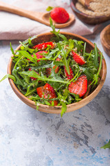Diet menu concept. Summer Healthy salad with quinoa, strawberry, and arugula. Top view flat lay background on light stone table with copy space.