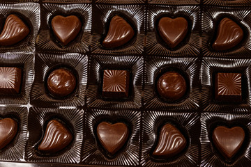Assorted chocolate candies in a box. Close-up