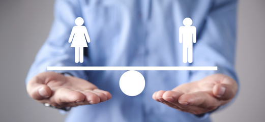 Man showing balance scale. Man and Woman equality