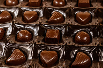Assorted chocolate candies in a box. Close-up