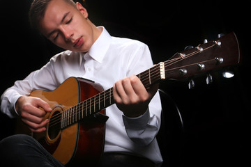 Young men playing the guitar