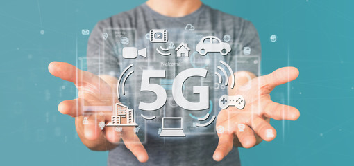 Businessman holding a 5G connection with data surrounding - 3d rendering