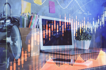 Financial chart drawing and table with computer on background. Double exposure. Concept of international markets.