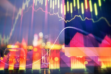 Financial graph colorful drawing and table with computer on background. Multi exposure. Concept of international markets.