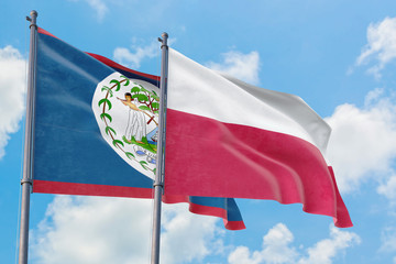 Fototapeta na wymiar Poland and Belize flags waving in the wind against white cloudy blue sky together. Diplomacy concept, international relations.