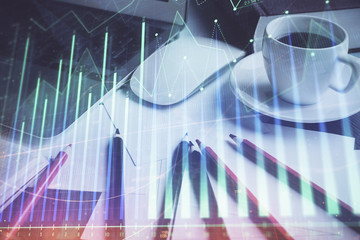 Stock market chart hologram drawn on personal computer background. Double exposure. Concept of investment.