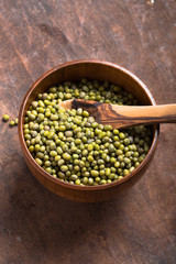 Green mung beans in bowl on wooden  background /  bean seed cereal whole grains