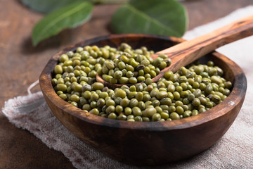 Green mung beans in bowl on wooden  background /  bean seed cereal whole grains