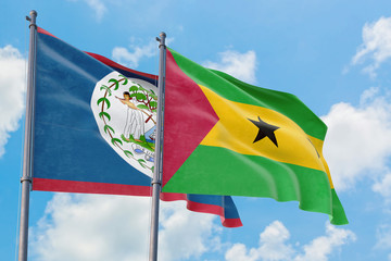 Sao Tome And Principe and Belize flags waving in the wind against white cloudy blue sky together. Diplomacy concept, international relations.