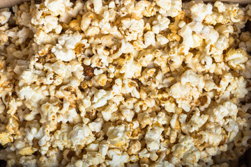 Fresh popcorn textured background. Cinema snack concept. The food for watching a movie and entertainment.