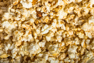 Fresh popcorn textured background. Cinema snack concept. The food for watching a movie and entertainment.