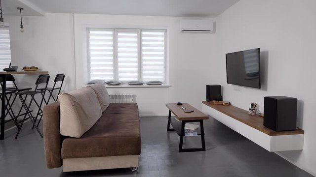 Stylish modern living room. Apartments for rent. TV and sofa with a coffee table.