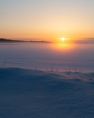 Sunset landscape on frozen winter lake in Finland