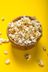 Popcorn viewed from above on yellow background. Flat lay  bowl. Top view